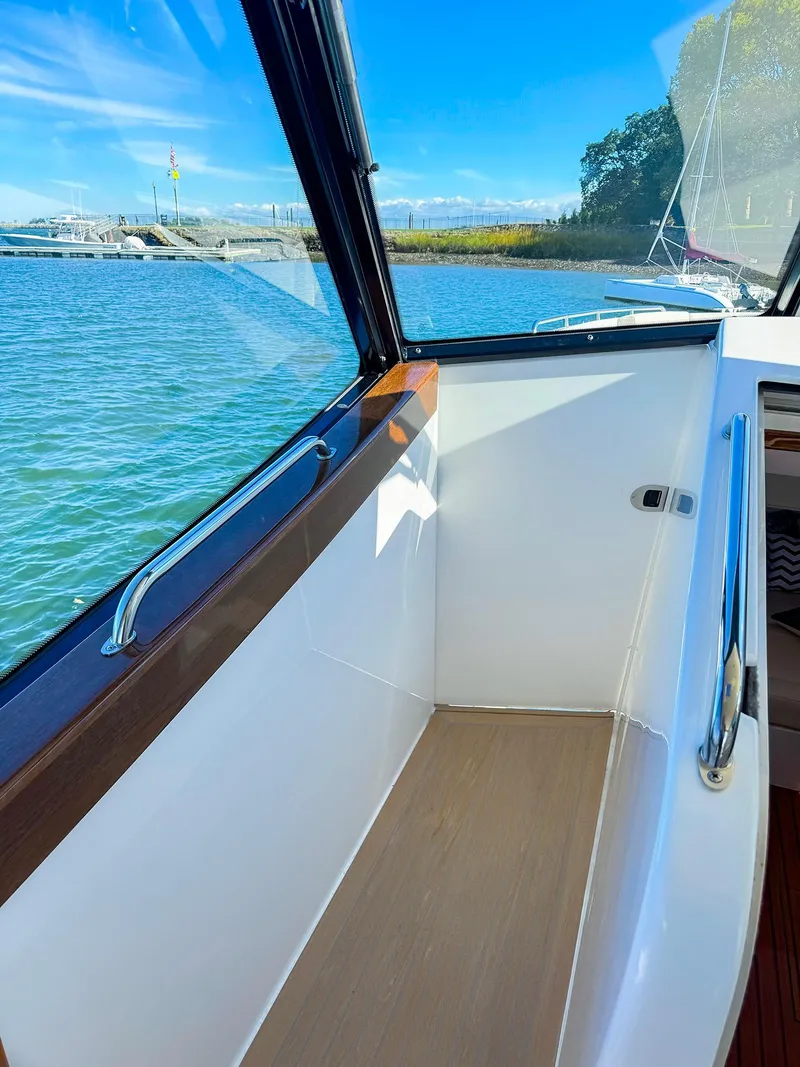 Slide: The Image of 2024 MJM 4 boat interior with scenic water view. - 26