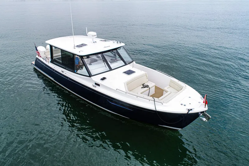 Slide: The Image of 2024 MJM 4 boat on calm water, featuring sleek design and spacious seating. - 3