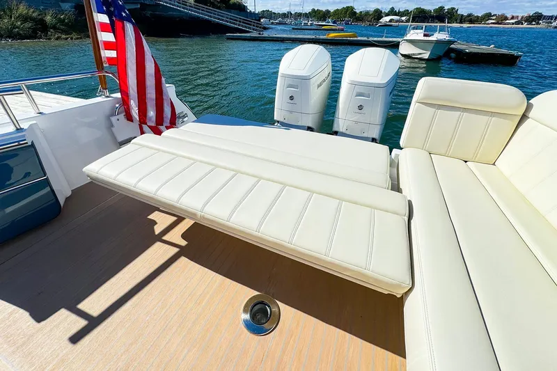 Slide: The Image of 2024 MJM 4 boat with plush seating and dual engines on a sunny day. - 30