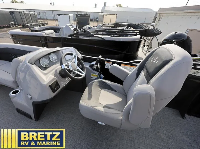 Slide: The Image of Aria Ultra-Lounge A22UC 2025 boat interior with steering console and seating at Bretz RV & Marine. - 12