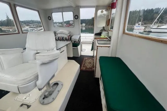 Slide: The Image of Interior of a 1972 REPCO Buxton Downeast Hardtop Cruiser with white seating and green cushions. - 10