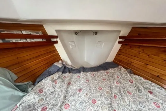 Slide: The Image of 1972 REPCO Buxton Downeast Hardtop Cruiser cabin with wooden paneling and patterned bedding. - 13