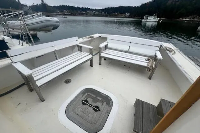 Slide: The Image of 1972 REPCO Buxton Downeast Hardtop Cruiser with white benches on a calm lake. - 21
