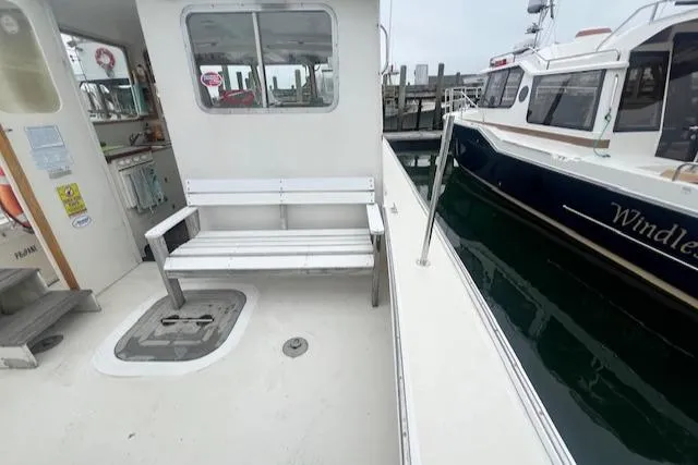 Slide: The Image of 1972 REPCO Buxton Downeast Hardtop Cruiser with white bench and docked boat. - 27