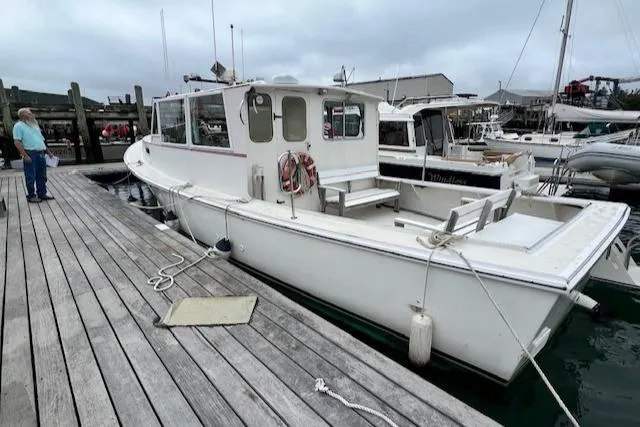 Slide: The Image of 1972 REPCO Buxton Downeast Hardtop Cruiser docked at a marina. - 30