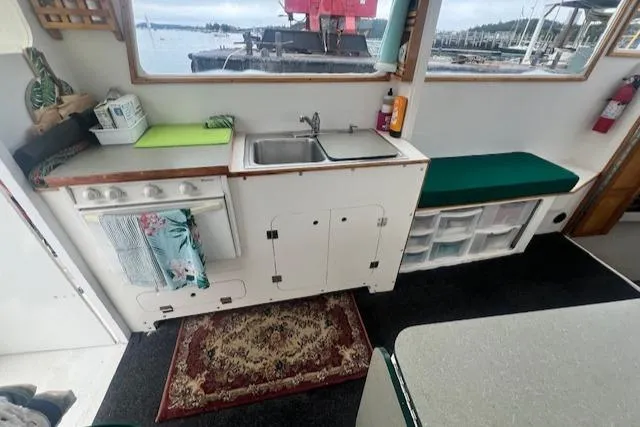 Slide: The Image of 1972 REPCO Buxton Downeast Hardtop Cruiser interior with kitchenette and marina view. - 7