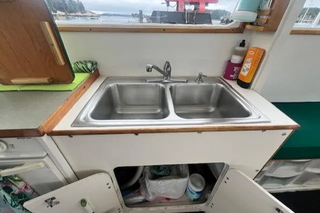 Slide: The Image of 1972 REPCO Buxton Downeast Hardtop Cruiser kitchen with double sink and storage. - 8