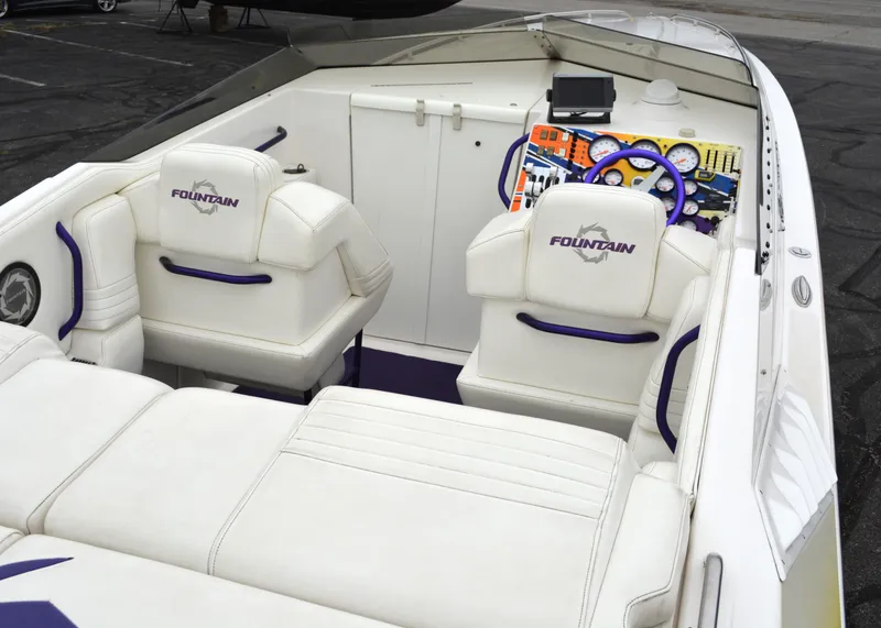 Slide: The Image of 2007 Fountain 35 Executioner boat interior with white seating and colorful dashboard. - 10