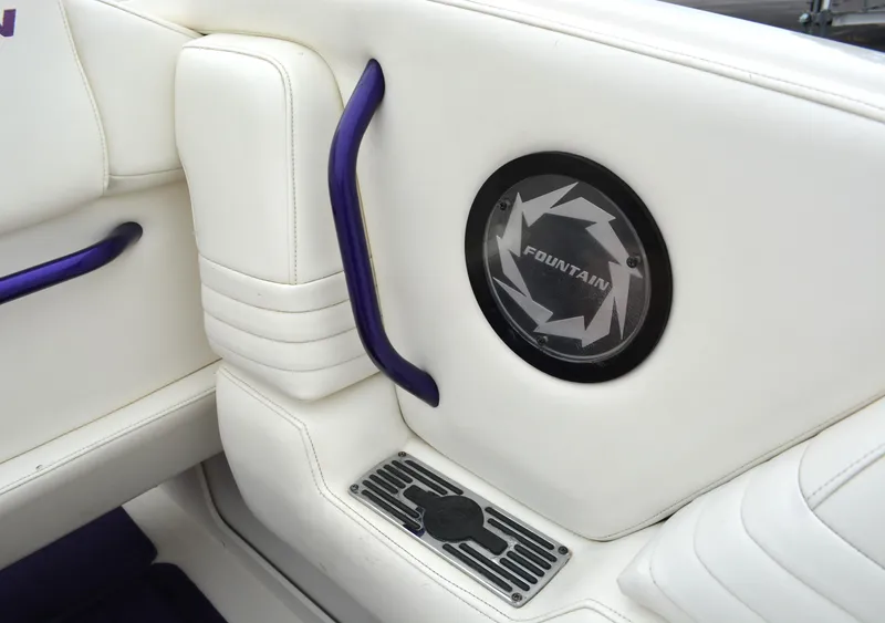 Slide: The Image of 2007 Fountain 35 Executioner boat interior with white leather seats and purple accents. - 12