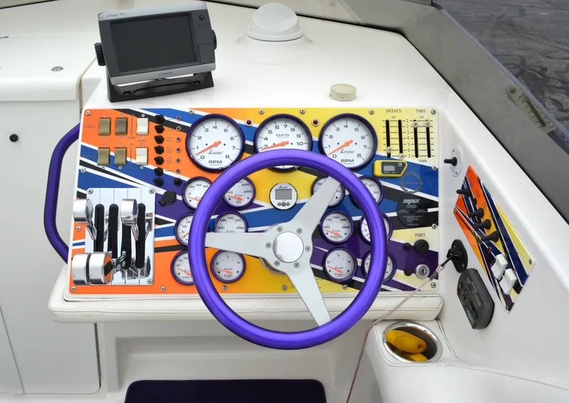 Slide: The Image of 2007 Fountain 35 Executioner boat dashboard with colorful gauges and purple steering wheel. - 14