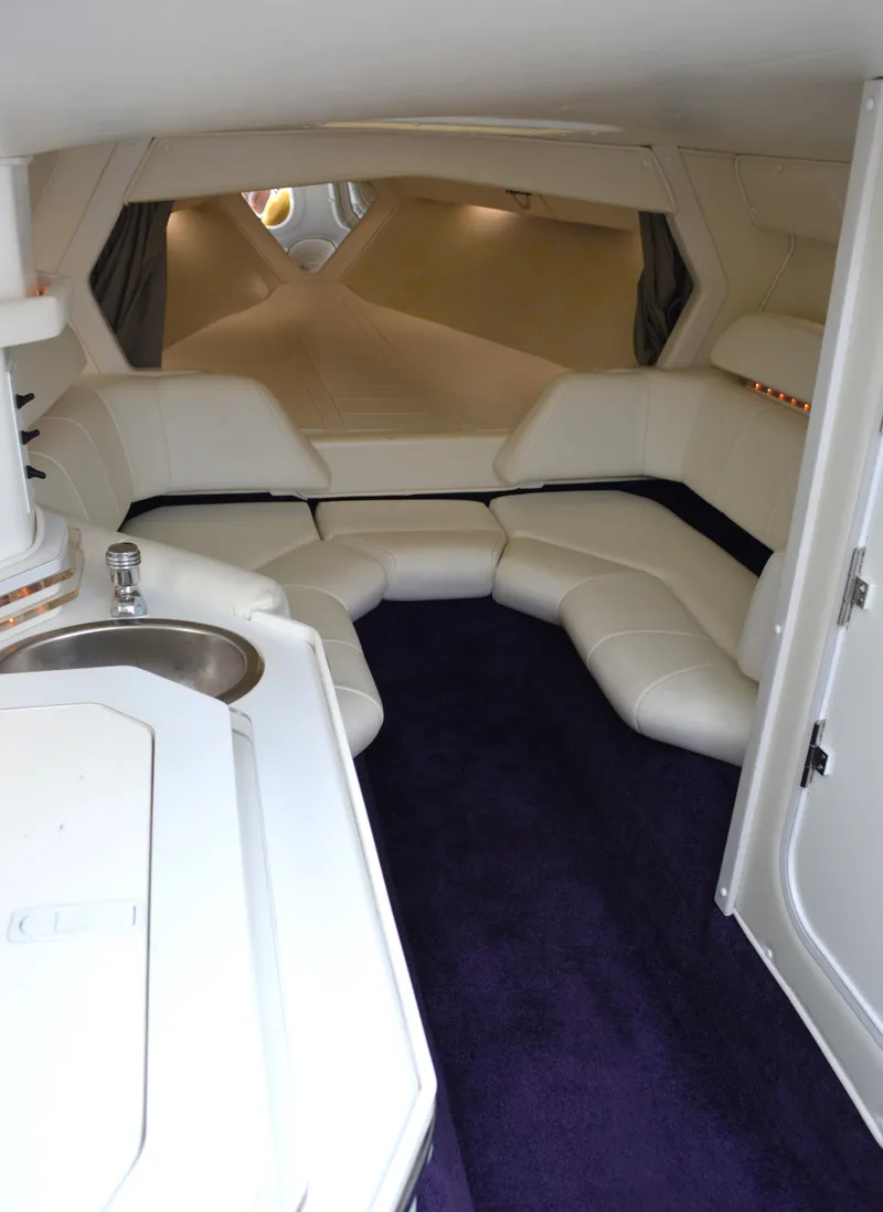 Slide: The Image of Interior of 2007 Fountain 35 Executioner boat with white seating and purple carpet. - 18