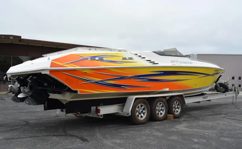 Slide: The Image of 2007 Fountain 35 Executioner speedboat with vibrant orange and yellow design on a trailer. - 2