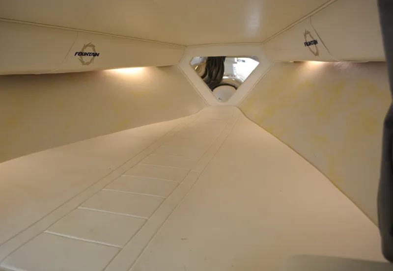 Slide: The Image of Interior cabin of 2007 Fountain 35 Executioner boat, featuring sleek design and ambient lighting. - 21