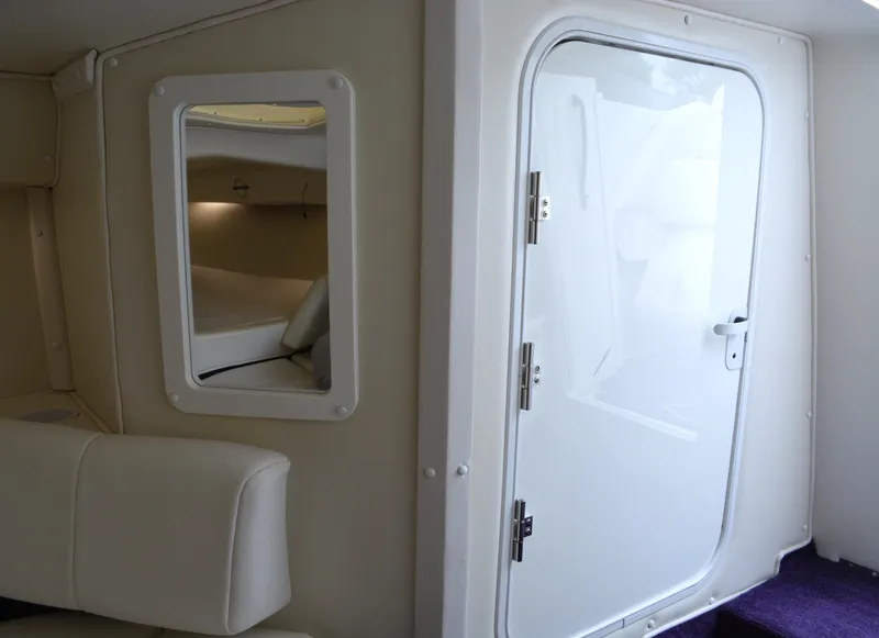 Slide: The Image of Interior of 2007 Fountain 35 Executioner boat with white door and seating. - 24