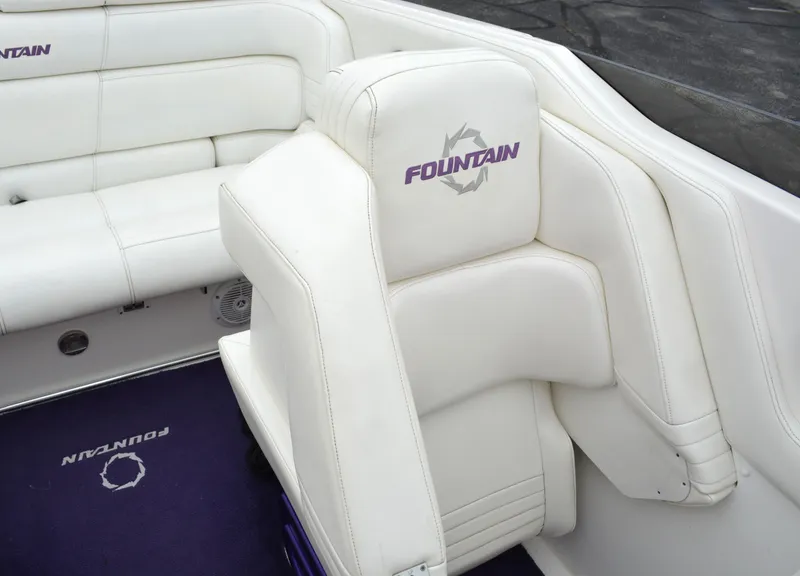Slide: The Image of 2007 Fountain 35 Executioner boat interior with white leather seating and purple logo. - 28