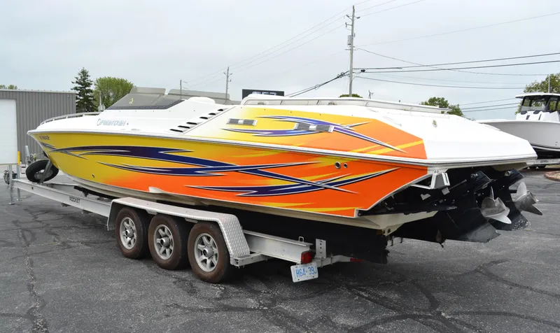 Slide: The Image of 2007 Fountain 35 Executioner speedboat with vibrant orange and blue graphics on a trailer. - 4
