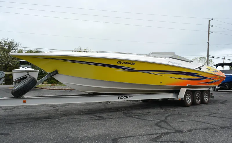 Slide: The Image of 2007 Fountain 35 Executioner speedboat on trailer, vibrant yellow with blue and orange accents. - 6