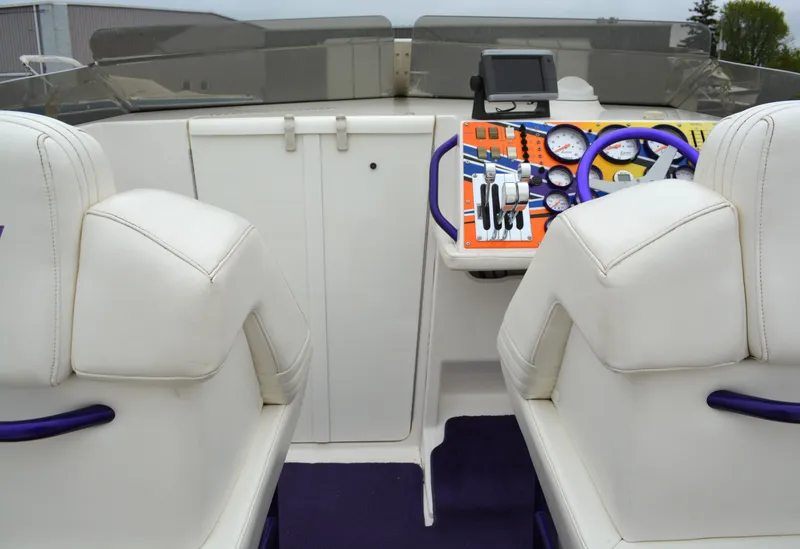 Slide: The Image of 2007 Fountain 35 Executioner boat interior with white seats and colorful dashboard. - 9
