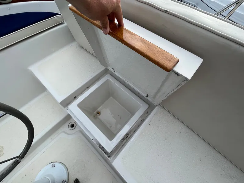 Slide: The Image of Storage compartment on 1981 Endeavour 40 sailboat, featuring a wooden handle and white interior. - 11