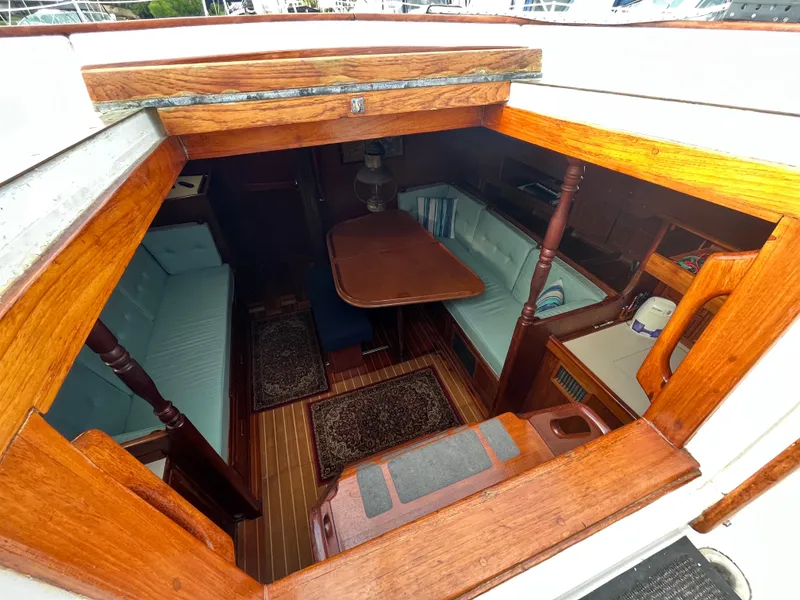 Slide: The Image of Interior view of 1981 Endeavour 40 sailboat with wooden furnishings and seating area. - 13