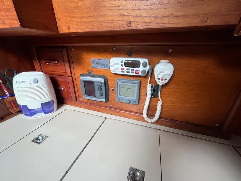 Slide: The Image of 1981 Endeavour 40 yacht interior with radio and control panel on wooden wall. - 18