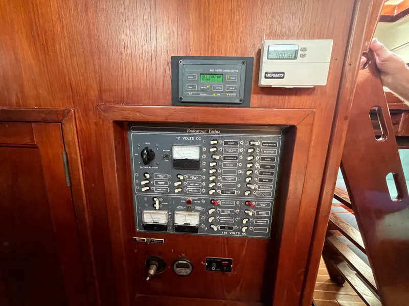 Slide: The Image of Electrical control panel on a 1981 Endeavour 40 sailboat, featuring various switches and gauges. - 20