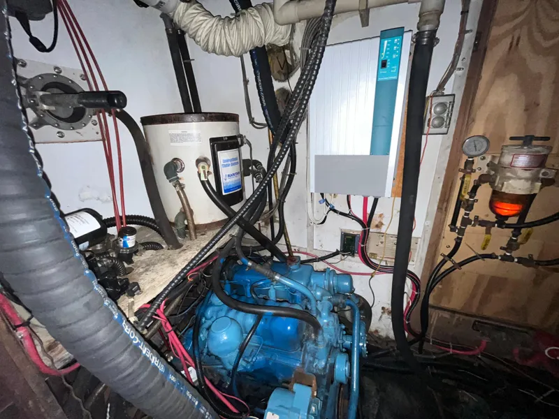 Slide: The Image of Engine room of a 1981 Endeavour 40 sailboat with visible wiring and components. - 22