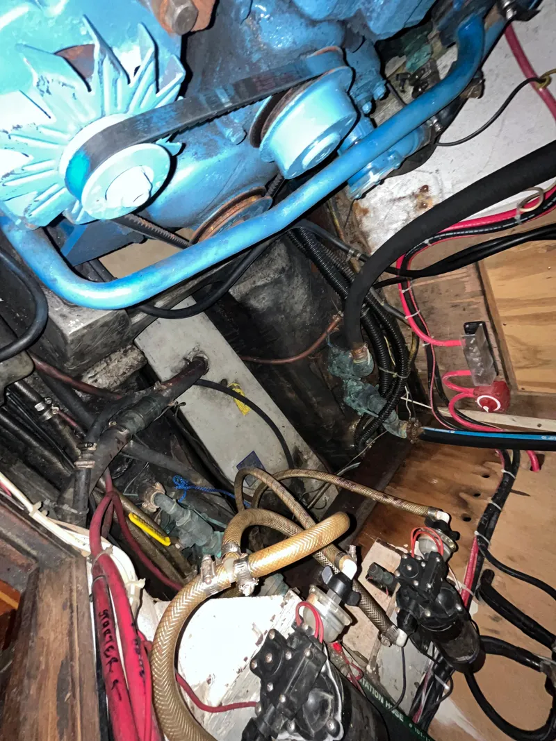 Slide: The Image of Engine compartment of a 1981 Endeavour 40 sailboat, showing mechanical components and wiring. - 25