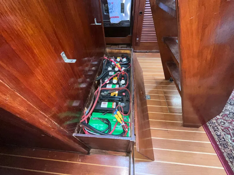 Slide: The Image of Battery compartment in 1981 Endeavour 40 sailboat with wooden interior. - 27