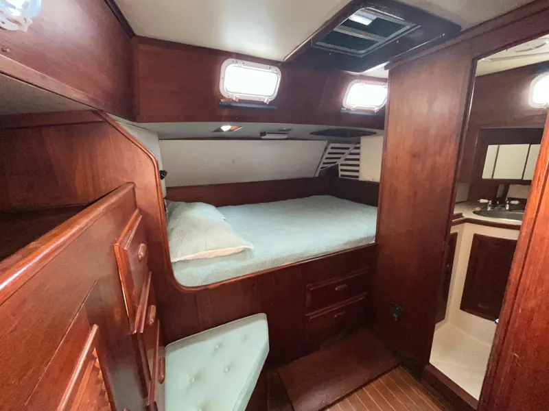 Slide: The Image of 1981 Endeavour 40 yacht cabin with wooden interior and cozy bed. - 28