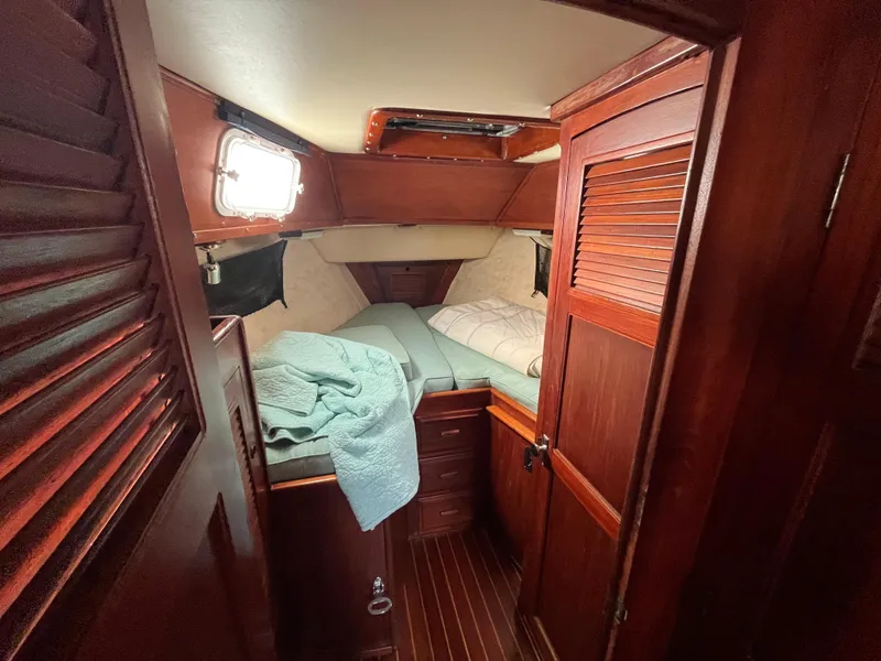 Slide: The Image of Cozy cabin interior of 1981 Endeavour 40 sailboat with wooden furnishings and bedding. - 32