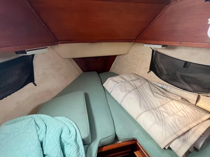Slide: The Image of Cozy cabin interior of 1981 Endeavour 40 sailboat with bedding and storage nets. - 34