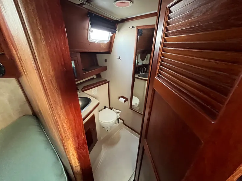 Slide: The Image of 1981 Endeavour 40 yacht bathroom with wooden cabinetry and compact design. - 35