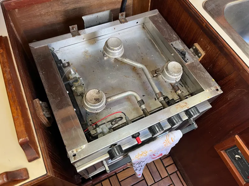 Slide: The Image of 1981 Endeavour 40 stove with three burners in a wooden boat galley. - 39