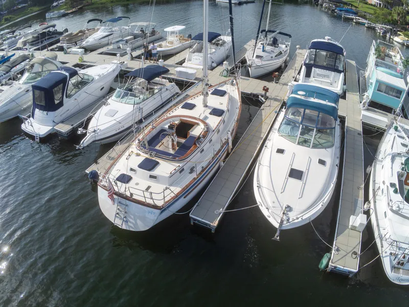 Slide: The Image of Aerial view of a 1981 Endeavour 40 sailboat docked among other boats at a marina. - 4