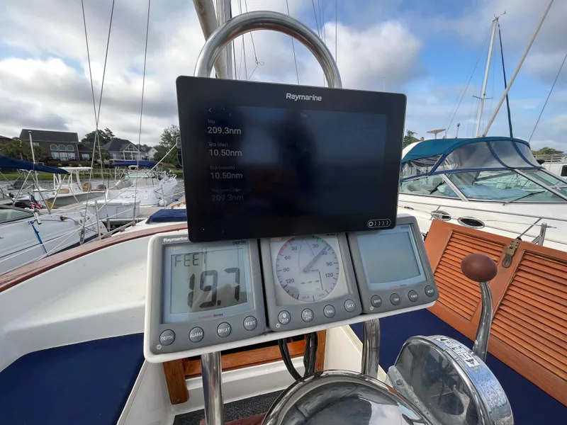 Slide: The Image of Cockpit of 1981 Endeavour 40 sailboat with navigation instruments and Raymarine display. - 9