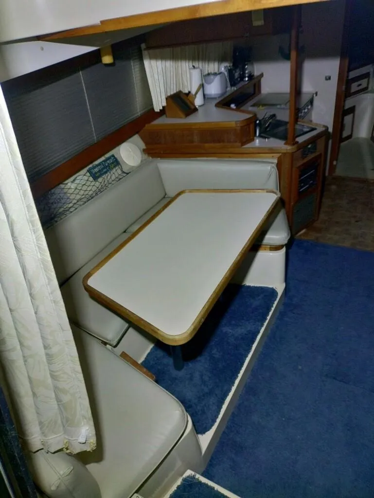 Slide: The Image of Interior of 1988 Carver Mariner 32 yacht with dining area and kitchen. - 13
