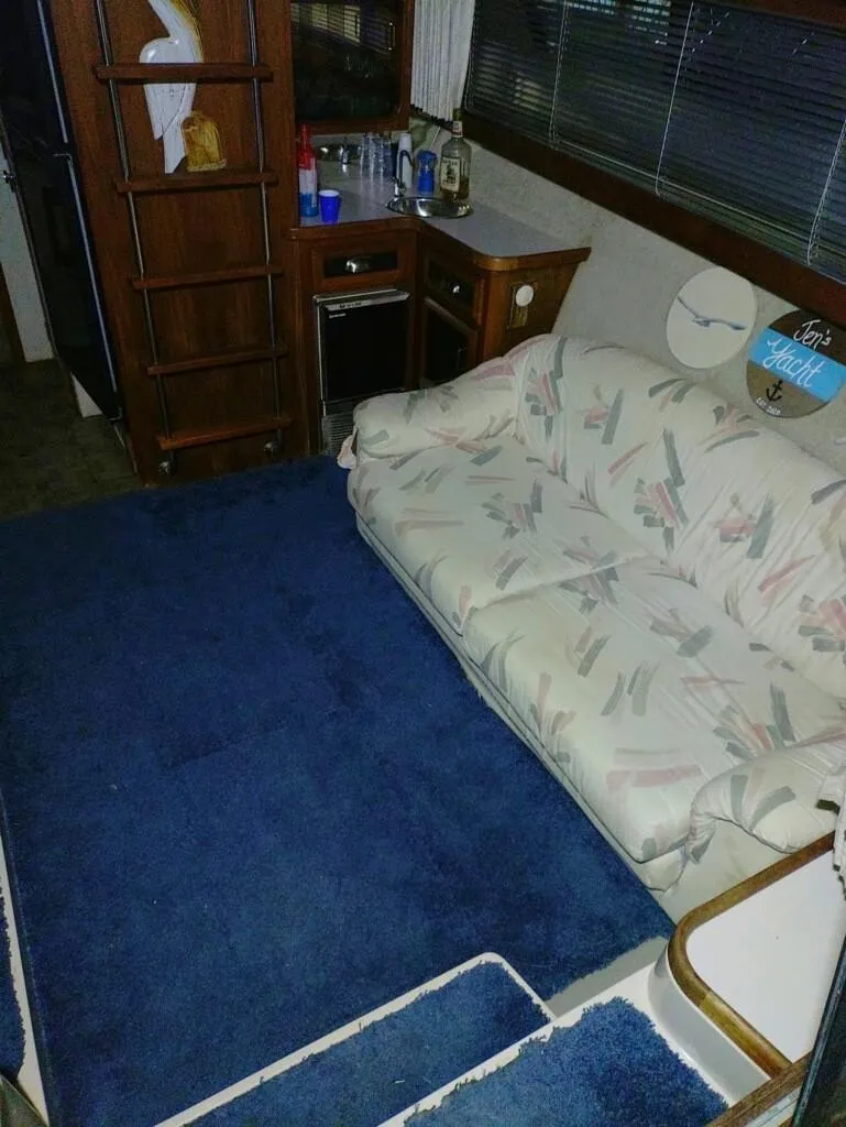 Slide: The Image of Interior of 1988 Carver Mariner 32 with blue carpet and patterned sofa. - 25