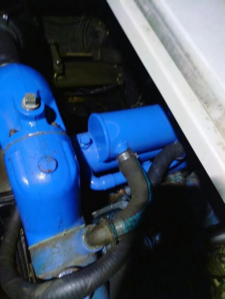 Slide: The Image of Engine compartment of 1988 Carver Mariner 32 with blue components and hoses. - 26