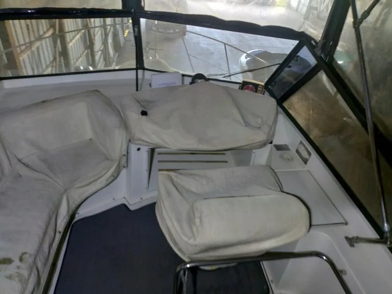 Slide: The Image of Interior of 1988 Carver Mariner 32 boat with covered seating and helm. - 5