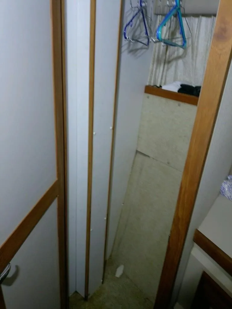 Slide: The Image of Narrow interior hallway of 1988 Carver Mariner 32 boat with hangers and wood trim. - 9