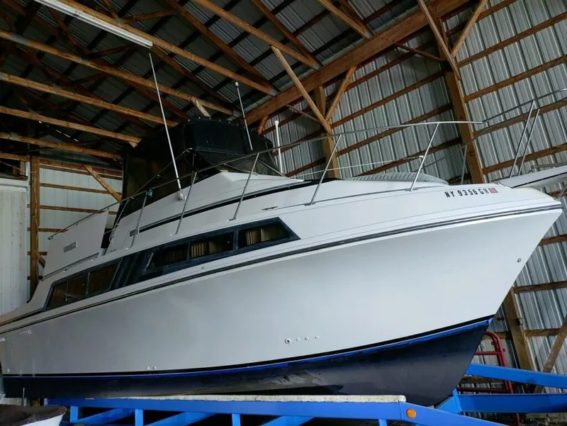 The Image of 1988 Carver Mariner 32 boat stored in a wooden boathouse. - 0