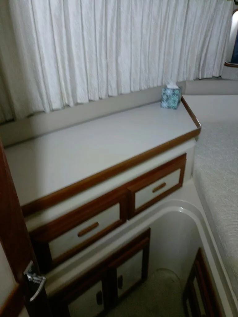 Slide: The Image of Interior of 1988 Carver Mariner 32 with wooden cabinets and curtains. - 10