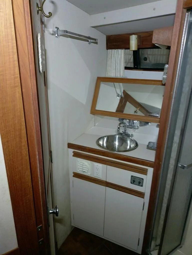 Slide: The Image of 1988 Carver Mariner 32 yacht bathroom with sink and mirror. - 11