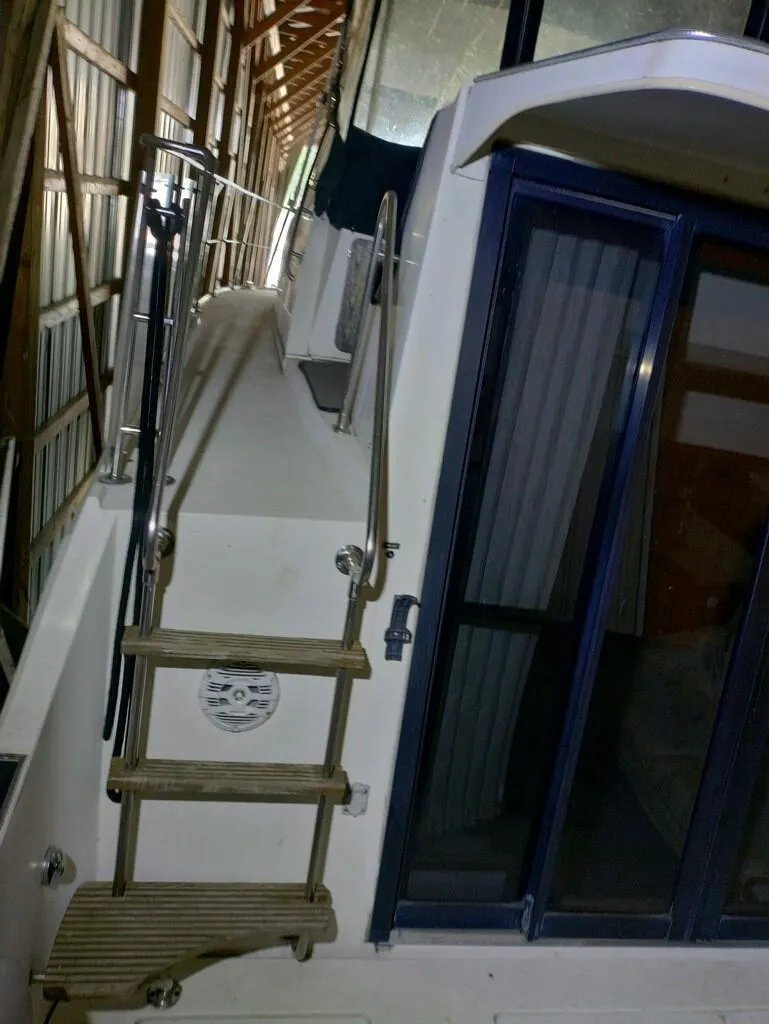 Slide: The Image of 1988 Carver Mariner 32 yacht with wooden steps and sliding glass door. - 15