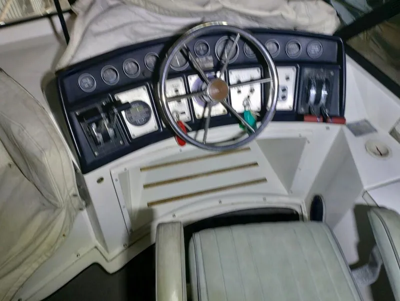 Slide: The Image of 1988 Carver Mariner 32 helm with steering wheel and control panel. - 16