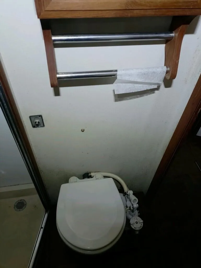 Slide: The Image of 1988 Carver Mariner 32 boat bathroom with toilet and towel rack. - 19