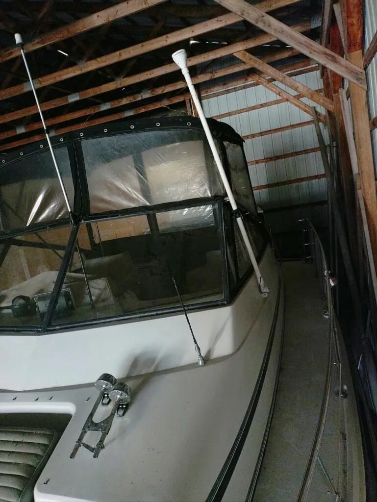 Slide: The Image of 1988 Carver Mariner 32 boat stored in a wooden shed. - 2
