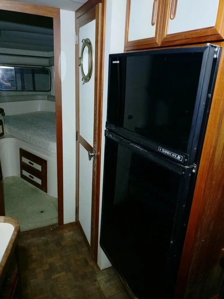 Slide: The Image of Interior of 1988 Carver Mariner 32 yacht with fridge and sleeping area. - 20
