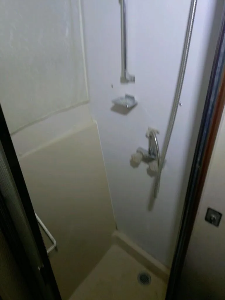 Slide: The Image of Shower area in 1988 Carver Mariner 32 boat, featuring compact design and fixtures. - 21